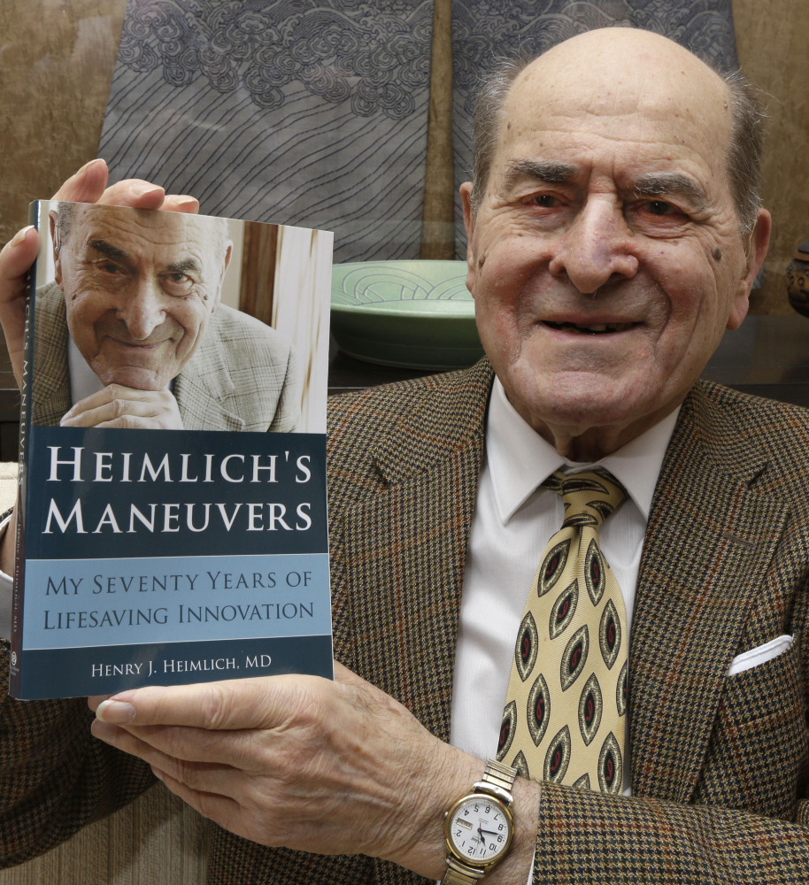 Henry Heimlich holds his memoir at his home in Cincinnati on Feb. 5.