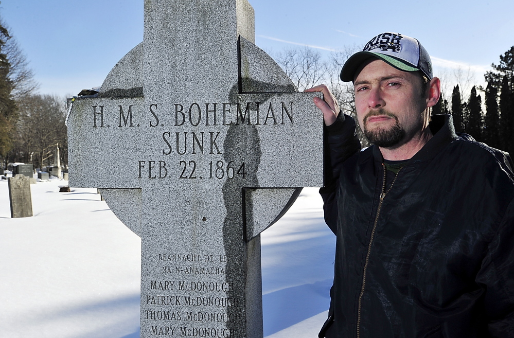Historian Matthew Jude Barker stands with the Celtic cross honoring victims of the RMS Bohemian shipwreck – “HMS” was an error, he said – in South Portland’s Calvary Cemetery.