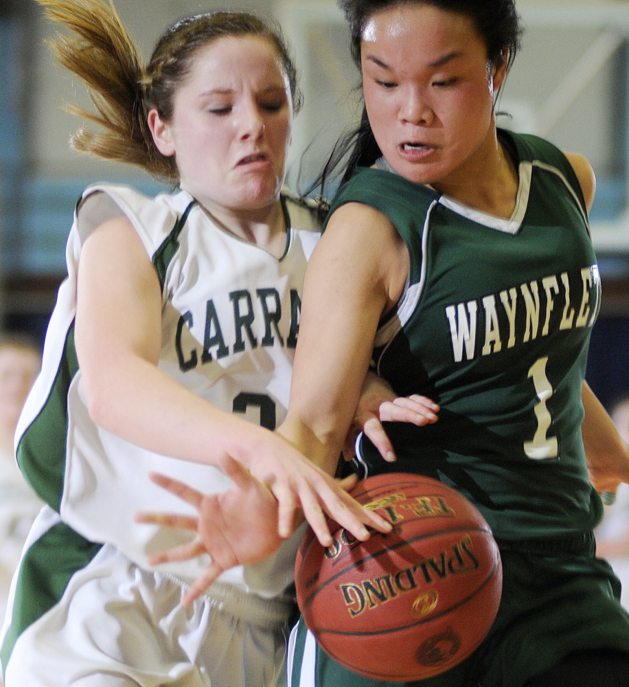 Carrabec’s Bailey Atwood, left, and Helen Gray-Bauer of Waynflete battle for the ball during their Western Class C quarterfinal Tuesday at the Augusta Civic Center. Carrabec won, 49-37.