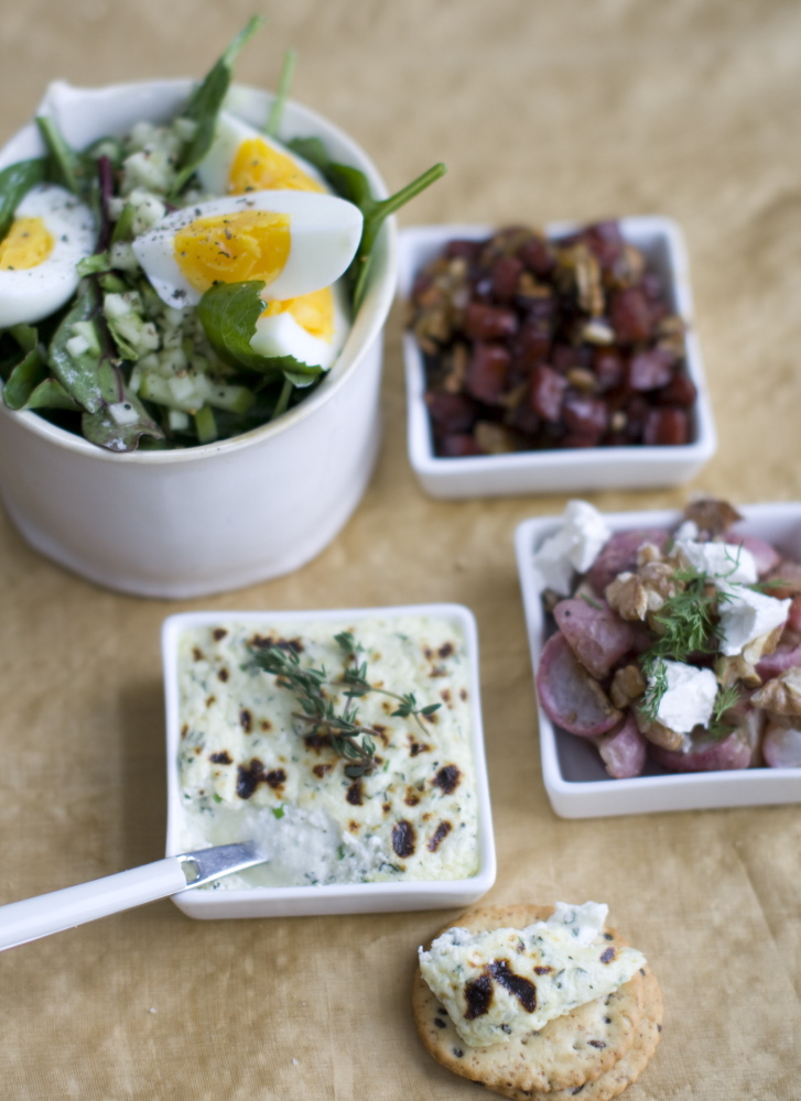 Cockwise from top right, seared maple kielbasa with raisins and sunflower seeds; butter-roasted radishes with dill, feta and walnuts; broiled herb ricotta; and soft boiled eggs with beet greens and apples.
