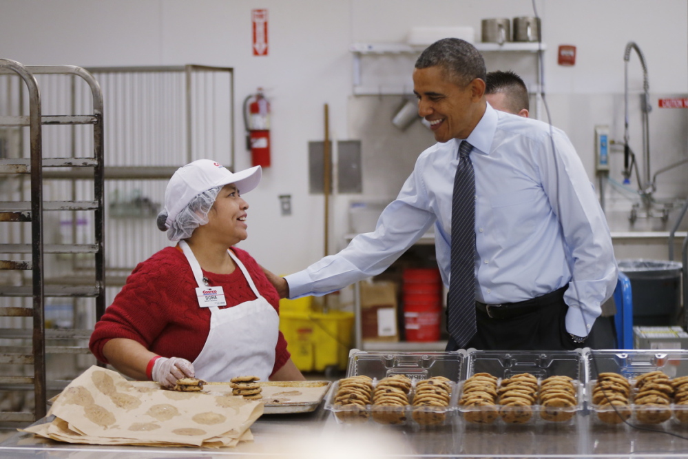 President Barack Obama talks with Dora Martinez, a baker at a Costco store in Lanham, Md., on Jan. 29, 2014, before his State of the Union speech in which he advocated raising the minimum wage.