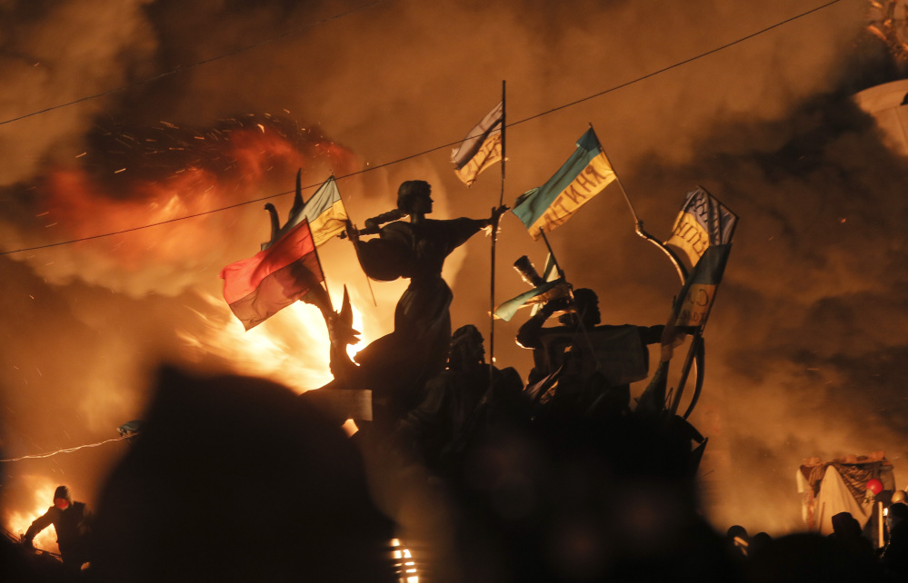 Monuments to Kiev’s founders burn as anti-government protesters clash with riot police in Kiev’s Independence Square, the epicenter of the country’s current unrest, on Tuesday.