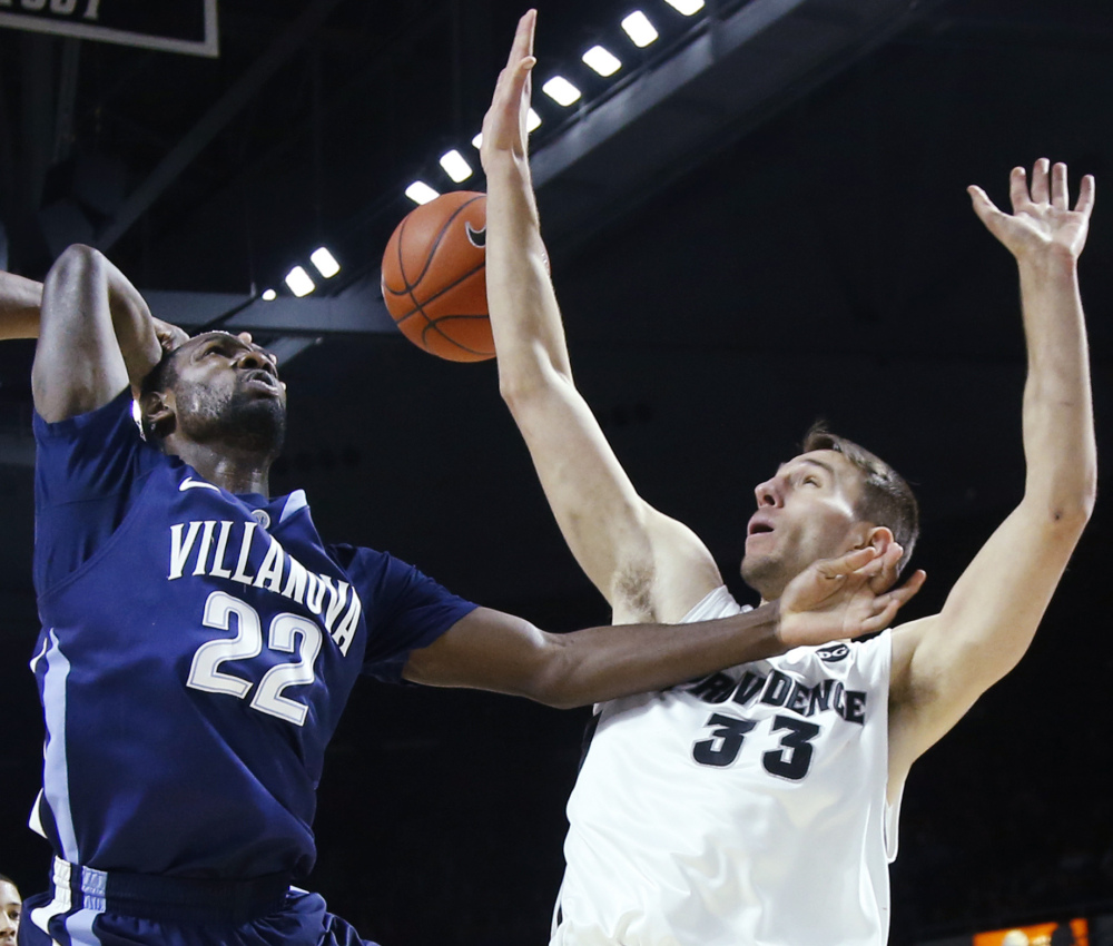 Villanova’s JayVaughn Pinkston, left, is fouled by Providence’s Carson Desrosiers during Tuesday’s game. Pinkston had 20 points in a double-overtime Villanova win.