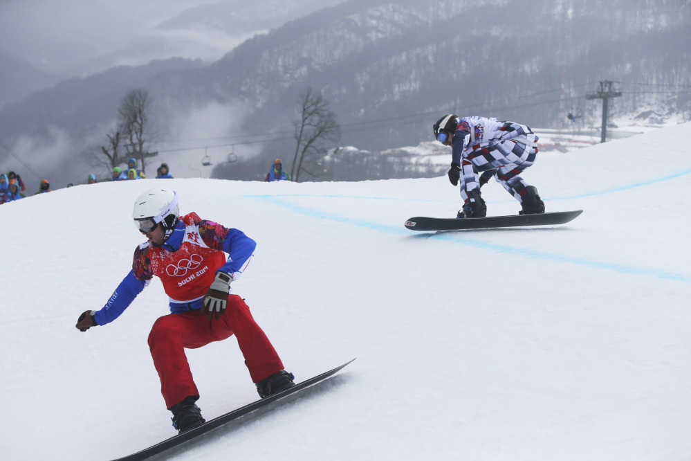 Gold medalist Pierre Vaultier of France, left, leads silver medalist Nikolai Olyunin of Russia, in the men’s snowboard cross final at the Rosa Khutor Extreme Park, at the 2014 Winter Olympics, Tuesday, Feb. 18, 2014, in Krasnaya Polyana, Russia.