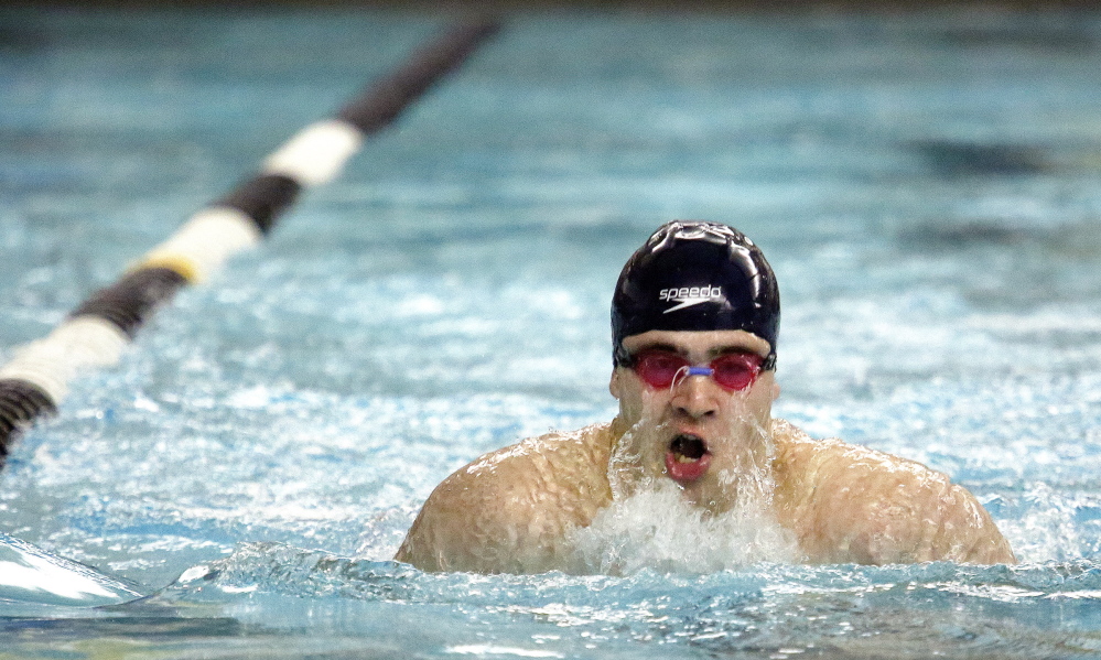 Griffin Fluet of Greely surfaces for air during the 100-yard breast stroke. Fluet finished fourth, helping Greely win its fifth straight team championship.