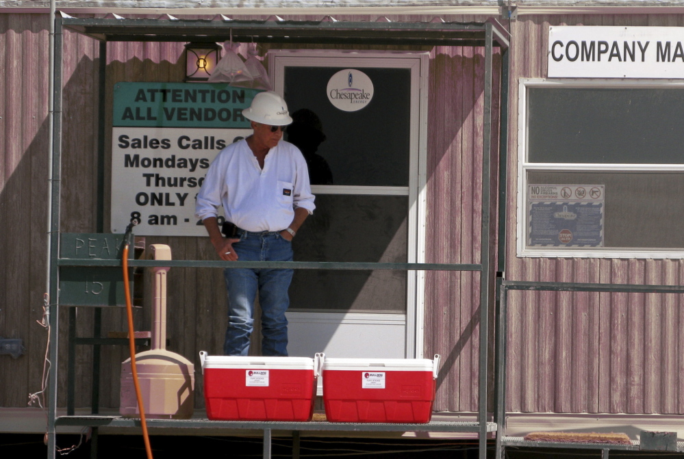 An oil worker takes a break at the Chesapeake Energy Corp., one of many companies tapping into the Eagle Ford shale in south Texas. In just a few years, the population of Carrizo Springs has gone from 5,600 to at least 40,000.