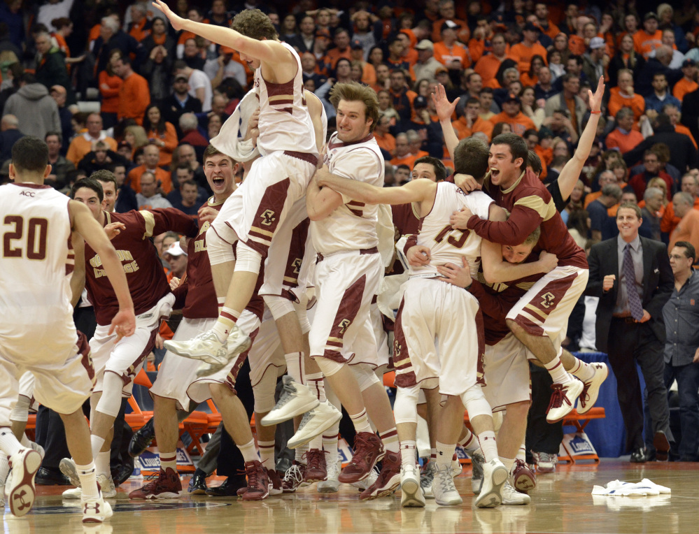 Boston College players celebrate after defeating Syracuse 62-59 in overtime in an NCAA college basketball game in Syracuse, N.Y., on Wednesday.