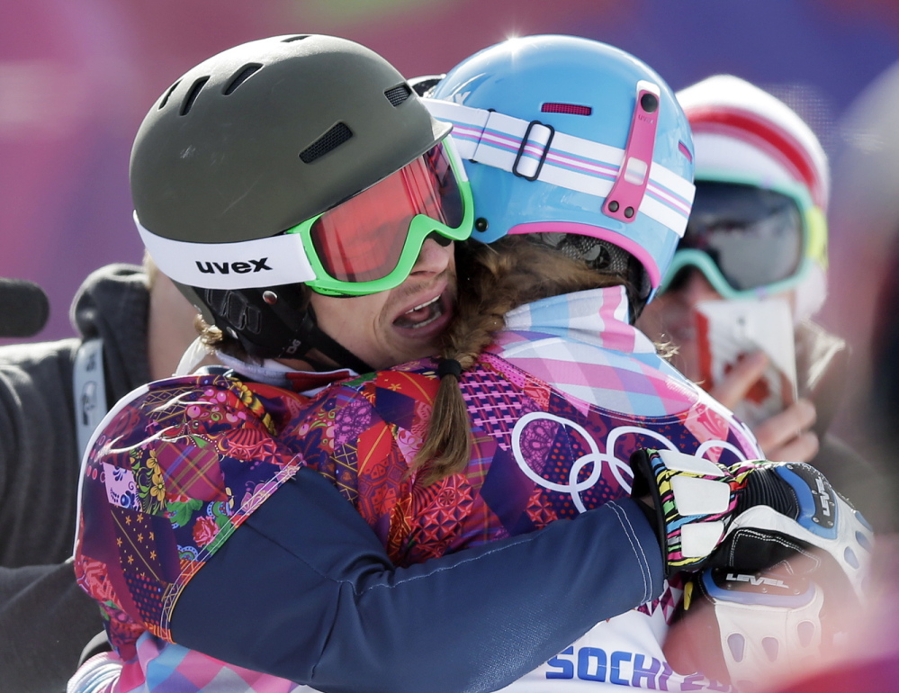 Russia’s Vic Wild, left, celebrates after winning the gold medal in the men’s snowboard parallel giant slalom final, with his wife and bronze medalist in the women’s snowboard parallel giant slalom final, Russia’s Alena Zavarzina, at the Rosa Khutor Extreme Park, at the 2014 Winter Olympics.