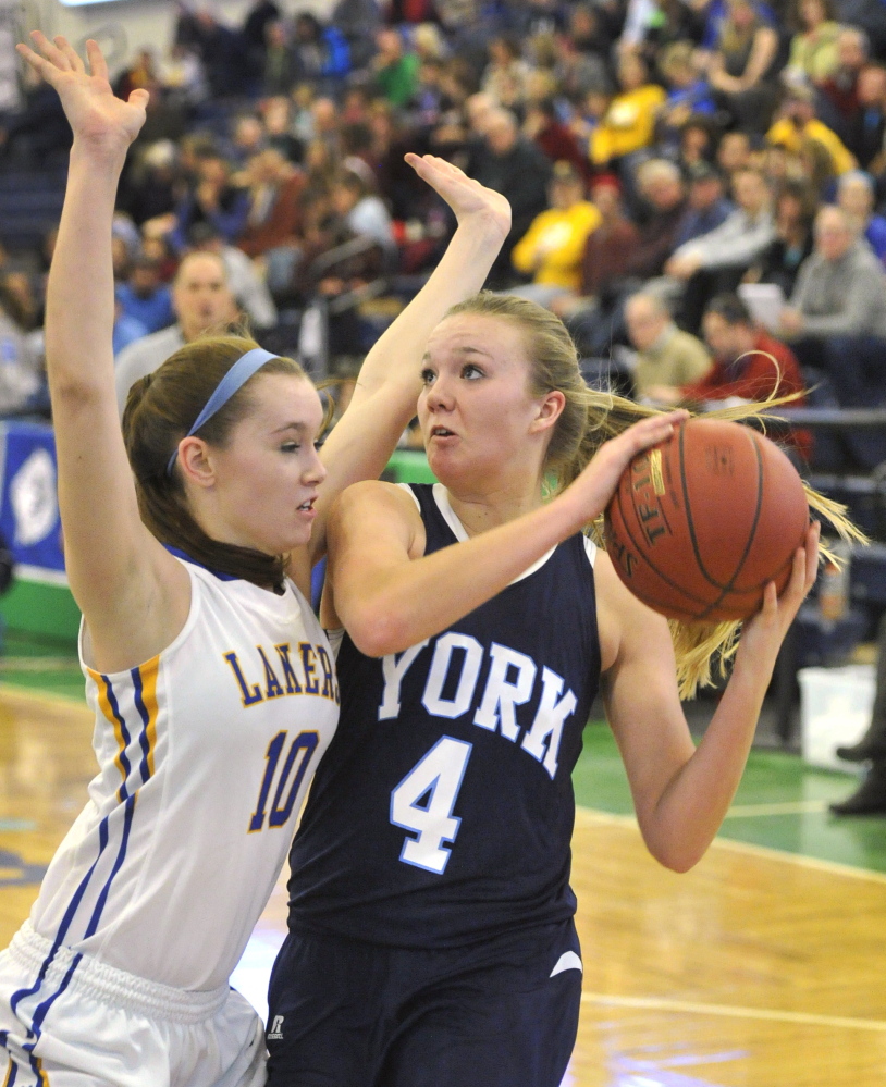 York’s Shannon Todd tries to drive to the basket against Jordan Turner of Lake Region during their Western Class B girls’ basketball quarterfinal Wednesday at the Portland Expo. Lake Region, the two-time defending regional champion, advanced with a 58-42 win.