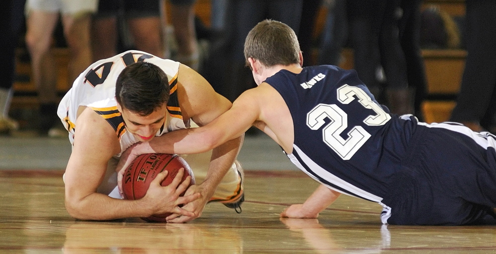 Hyde’s Talin Rowe, left, and North Haven’s Zebadiah Campbell wrestle for a loose ball during their Western Class D boys’ basketball semifinal Wednesday at the Augusta Civic Center. Hyde advanced with a 49-39 victory.