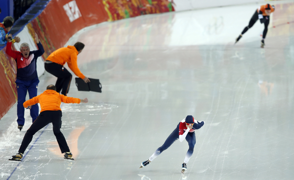 Coach Petr Novak of the Czech republic, left, screams as Martina Sablikova of the Czech Republic, front, skates against Ireen Wust of the Netherlands in the women’s 5,000-meter speedskating race at the Adler Arena Skating Center during the 2014 Winter Olympics In Sochi, Russia, Wednesday, Feb. 19, 2014.