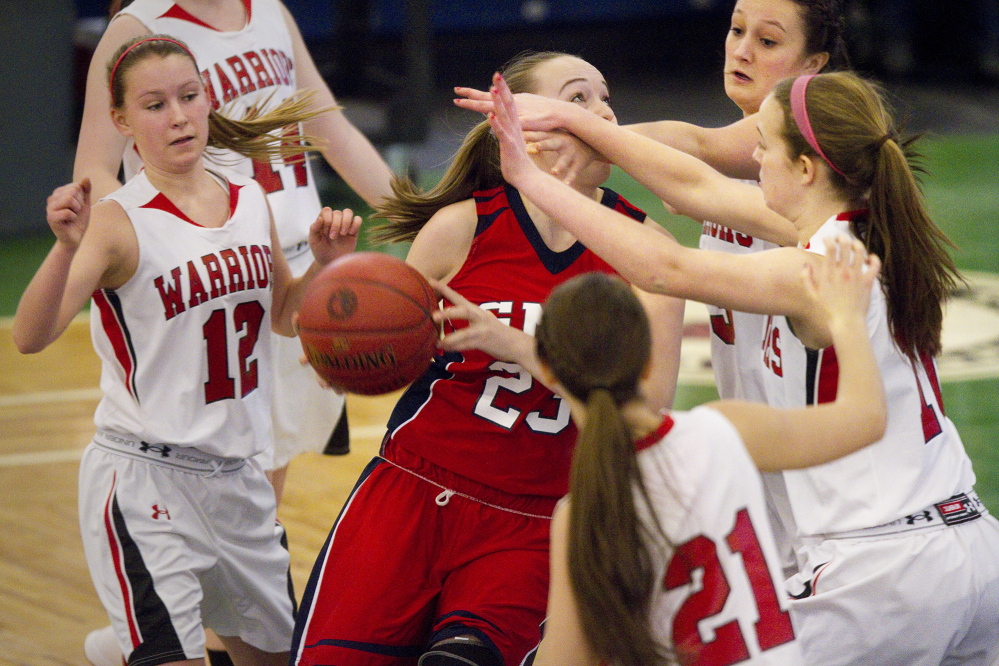 Wells defenders put heavy pressure on Gray-New Gloucester’s Alanna Camerl during their Western Class B girls’ basketball quarterfinal Wednesday at the Portland Expo. Wells won, 49-30.