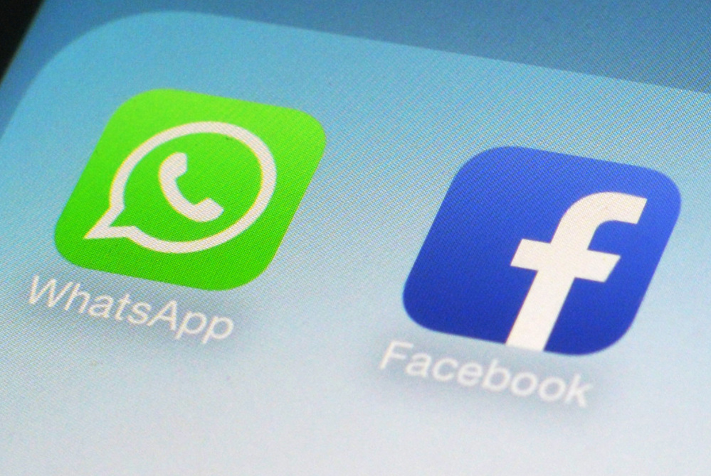 This Wednesday, Feb. 19, 2014 photo shows the WhatsApp and Facebook app icons on an iPhone in New York. On Wednesday the world’s biggest social networking company, Facebook, announced it is buying mobile messaging service WhatsApp for up to $19 billion in cash and stock.