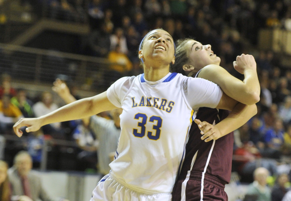 Tiana-Jo Carter, left, of Lake Region and Ashley Storey of Greely fight for rebounding position during their Western Class B girls’ basketball semifinal Thursday at the Cumberland County Civic Center. Top-seeded Lake Region advanced with a 43-32 win.
