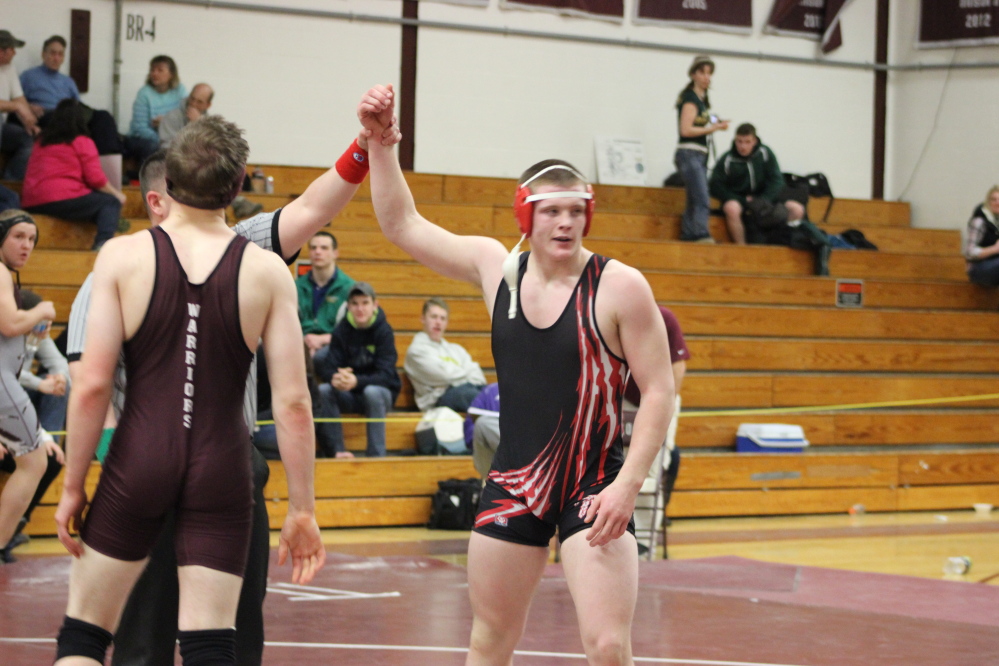 Michael Curtis, right, of Wells celebrates after winning a match Thursday at the first Maine New England qualifying tournament in Newport. Curtis won the 195-pound division.