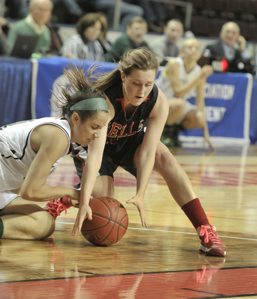 Vanesa Barnes, left, of Spruce Mountain and Stephanie Woods of Wells dive for a loose ball Thursday during their Western Class B girls’ basketball semifinal at the Cumberland County Civic Center. Wells eliminated Spruce Mountain for the second straight year, 55-31.