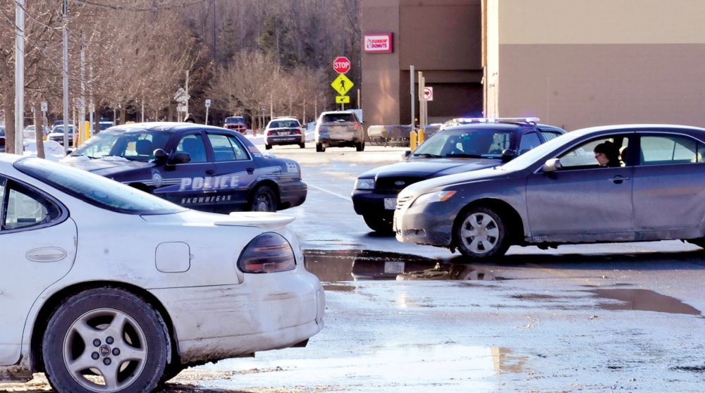Shoppers in vehicles are blocked by police cruisers from entering the Walmart parking lot in Skowhegan as police search the building after a reported bomb threat on Jan. 28.
