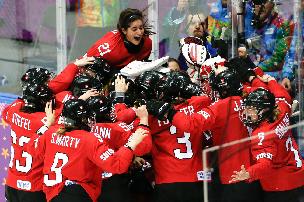 Team Switzerland celebrates their 4-3 win over Sweden in the women’s bronze medal ice hockey game at the 2014 Winter Olympics, Thursday, Feb. 20, 2014, in Sochi, Russia.