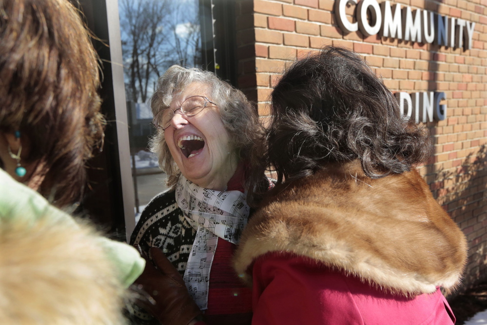 Helen Fisher, 80, laughs as she meets her nieces Barbara Garro of Saratoga Springs, N.Y., and Jean Carl of Exton, Pa., on Feb. 10 for the first time at the McGann Terrace Community Center in Fairhaven, Mass.