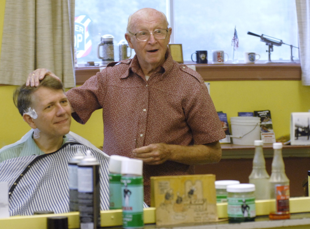 Barber “Red” Soucy shares a story with Gary McNeill of Waterboro at Soucy’s Saco barbershop in this 2007 photo. Soucy cut hair for nearly 60 years.