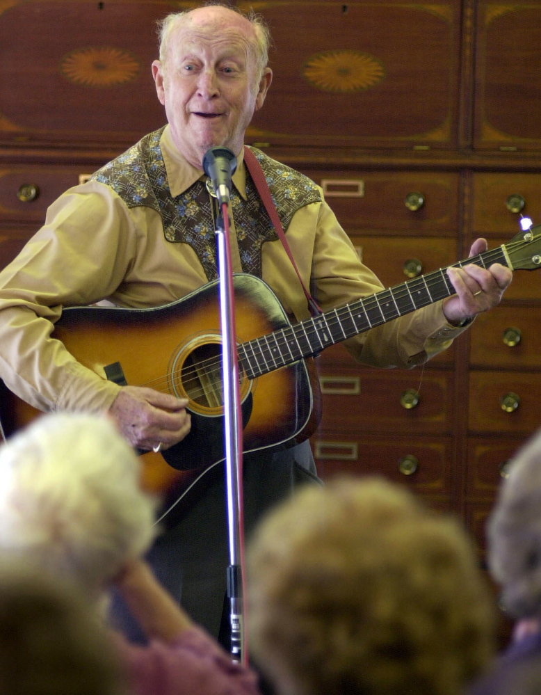2001 FILE PHOTO by Gregory Rec/Staff Photographer: On Friday, Feb. 2, 2001, Red Soucy launches into a song after telling a joke while performing at Dyer Library in Saco. His group, the Saco Troubadours, includes Roland J. Bergeron and Ray Laflamme.