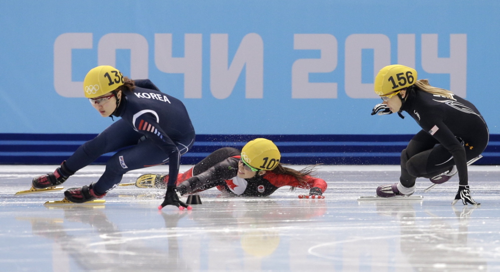 Valerie Maltais of Canada, center, crashes out as she competes with Park Seung-hi of South Korea, left, and Jessica Smith of the United States in a women’s 1000-meter short track speedskating semifinal at the Iceberg Skating Palace during the 2014 Winter Olympics on Friday in Sochi, Russia.