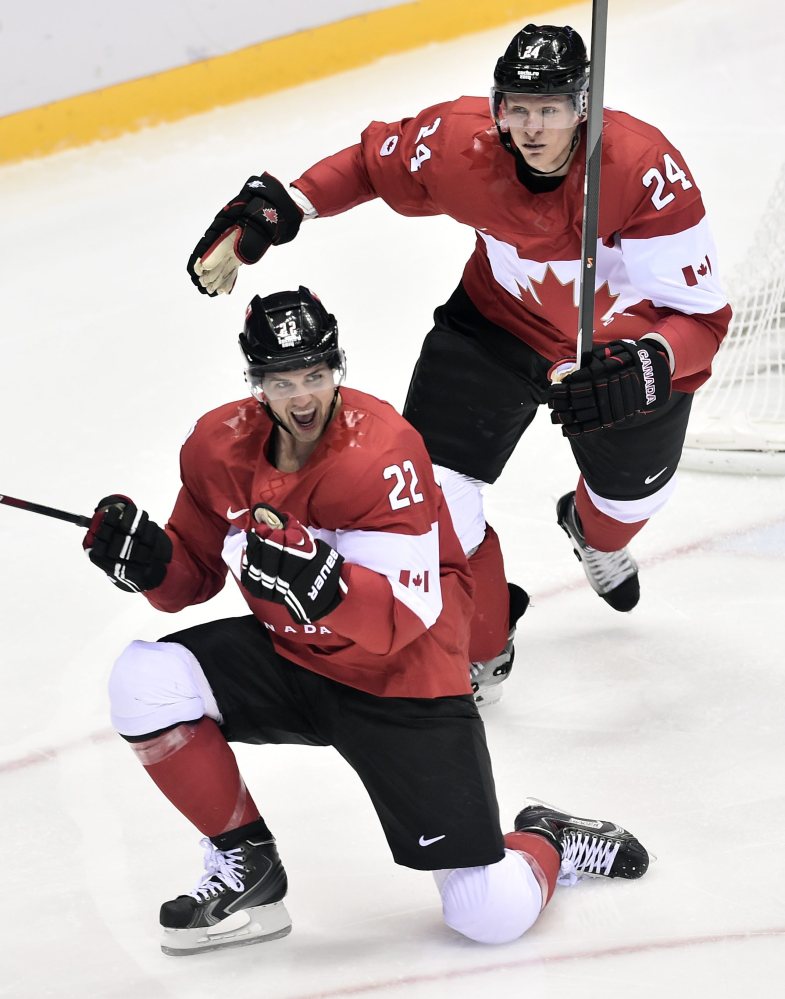 Canada’s Jamie Benn celebrates with Jeff Carter ,after scoring the first goal against the United States during the second period of the hockey semifinal at the 2014 Sochi Winter Olympics in Sochi, Russia on Friday.