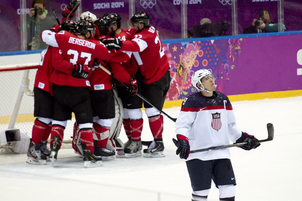 American forward Zach Parise looks up at the scoreboard as Canada celebrates its 1-0 victory in the men’s semifinal ice hockey game at the 2014 Winter Olympics on Friday in Sochi, Russia.