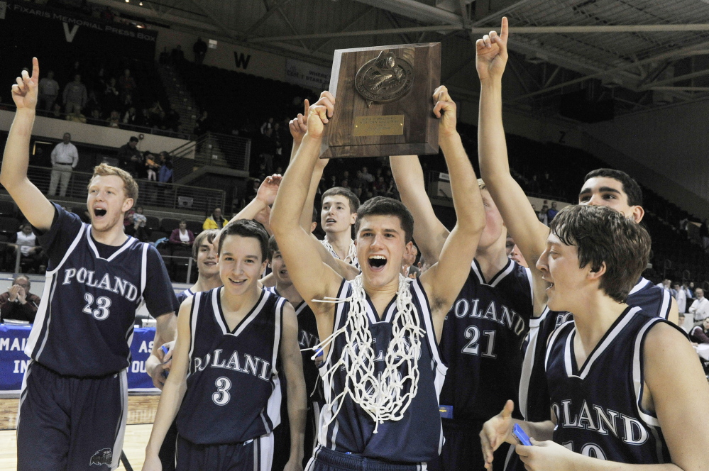 Poland captain Caleb Martin holds the Western Class B championship plaque after the Knights beat Greely 63-59 Saturday afternoon in the Western Class B boys’ basketball final at the Cumberland County Civic Center. Martin finished with 26 points, fueling Poland’s comeback from an early 19-point deficit.