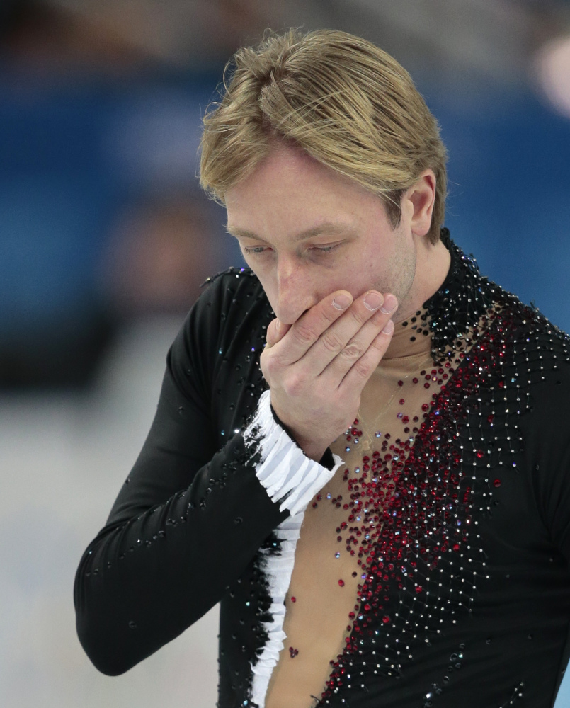 Evgeni Plushenko of Russia leaves the ice after pulling out of the men’s short program figure skating competition due to illness at the Iceberg Skating Palace during the 2014 Winter Olympics on Thursday.
