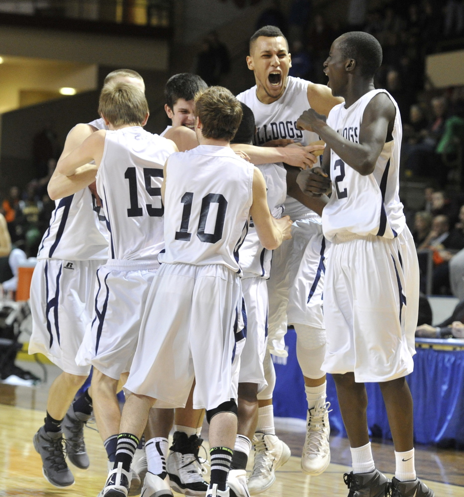 Portland players celebrate Saturday night after their 70-60 win over Bonny Eagle in the Western Class A boys’ basketball championship game at the Cumberland County Civic Center. The Bulldogs will play for the state title next Saturday against reigning champion Hampden Academy in a matchup of unbeaten teams.