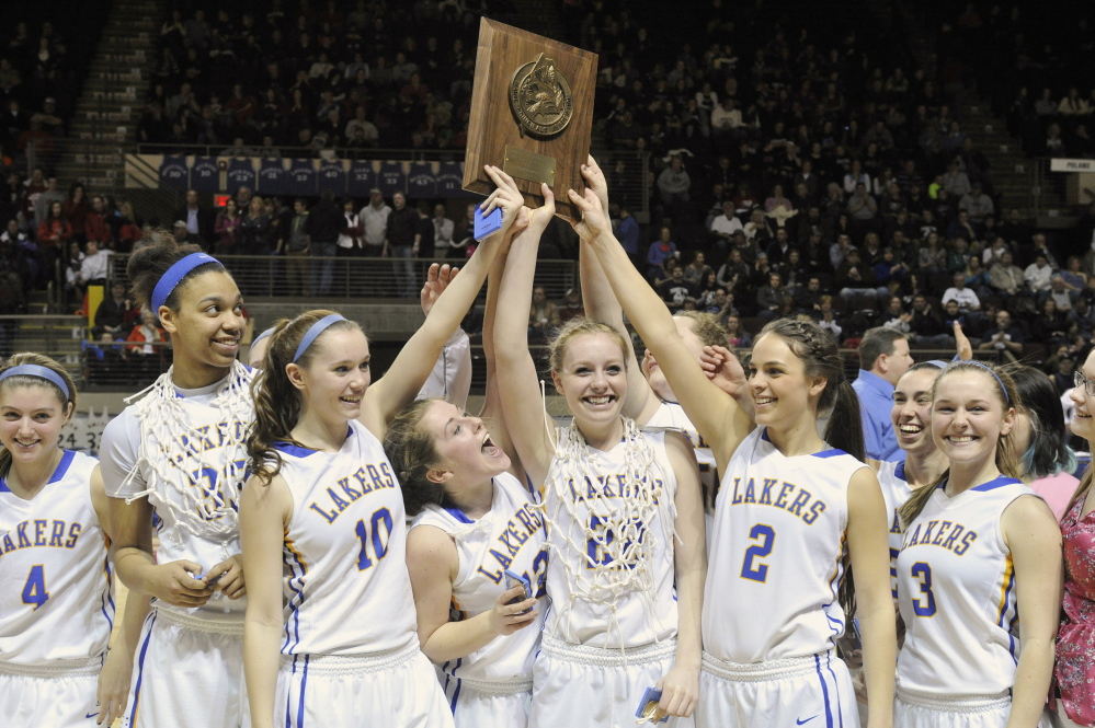 Lake Region players hold up the championship plaque after winning their third straight Western Class B title.