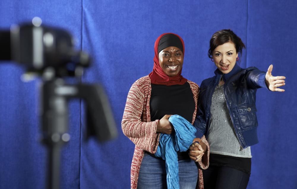 Samar (Hend Ayoub) directs Intisar (Donnetta Lavinia Grays) in a video about veiling for her blog in the Portland Stage Company production of Tom Coash’s “Veils.”