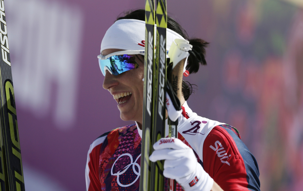 Norway’s Marit Bjoergen smiles after winning the gold during the women’s 30K cross-country race at the 2014 Winter Olympics Saturday.
