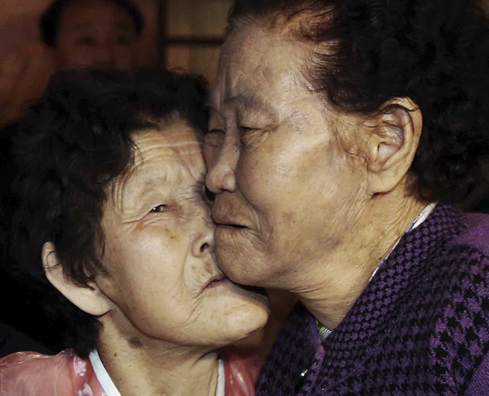 South Korean Lee Chun Hwa, right, gets a kiss from her North Korean sister, Lee Chun Son, at the Diamond Mountain resort in North Korea on Saturday. The siblings had been separated for six decades.