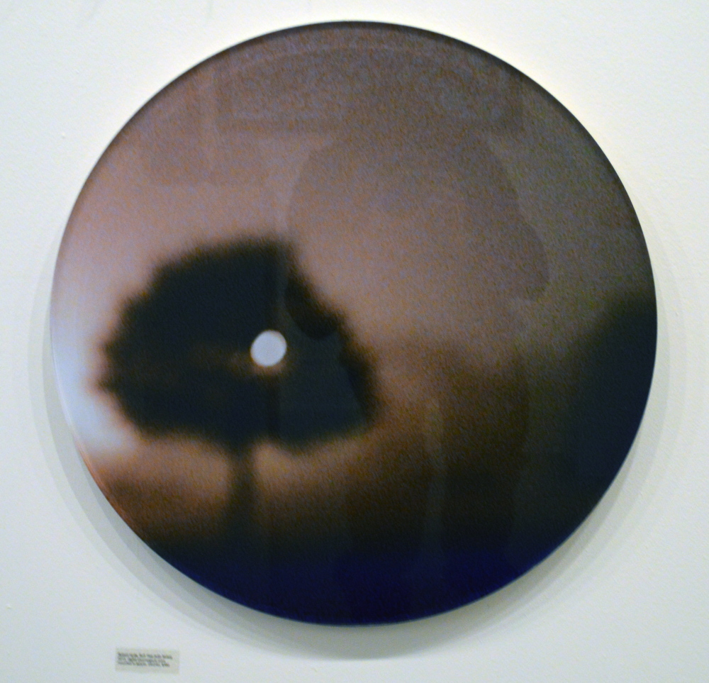 Photographic tondo face-mounted on Lucite by Robert Hyde, in “Free For All 4.”