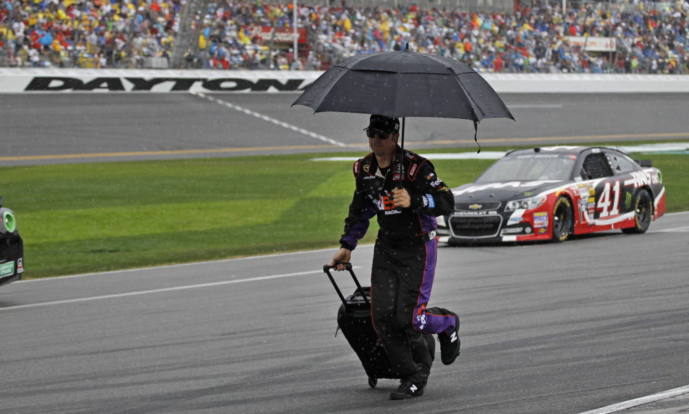 A crew member runs down pit road during a rain delay in the NASCAR Daytona 500 Sunday at Daytona Beach, Fla. The race was stopped after 38 laps.