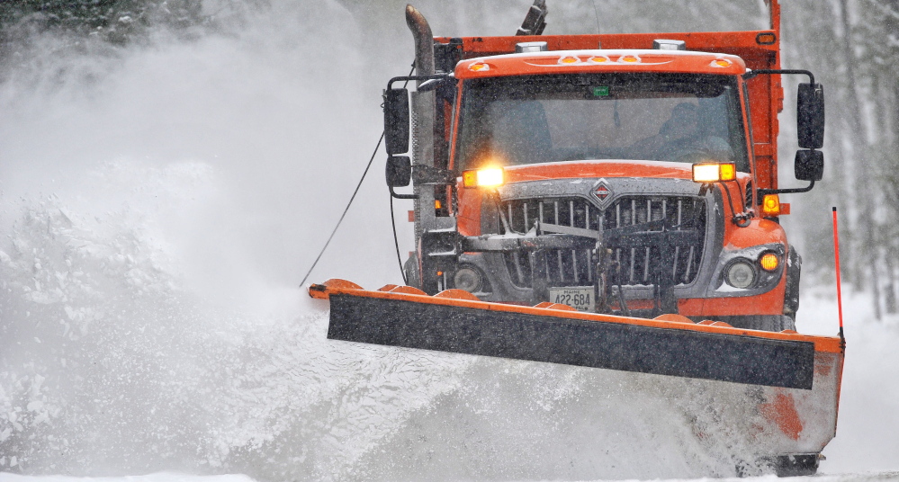A city plow clears snow in Waterville during a recent storm. The increased use of salt brine to coat roads before a storm hits lets communities spread less salt and sand, cutting spending and runoff into lakes and streams.