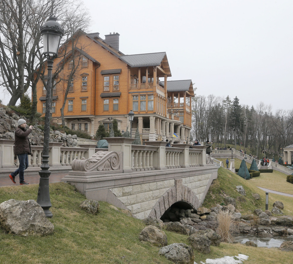 A man takes a photo on the grounds of Ukrainian President Yanukovych’s country residence in Mezhyhirya.