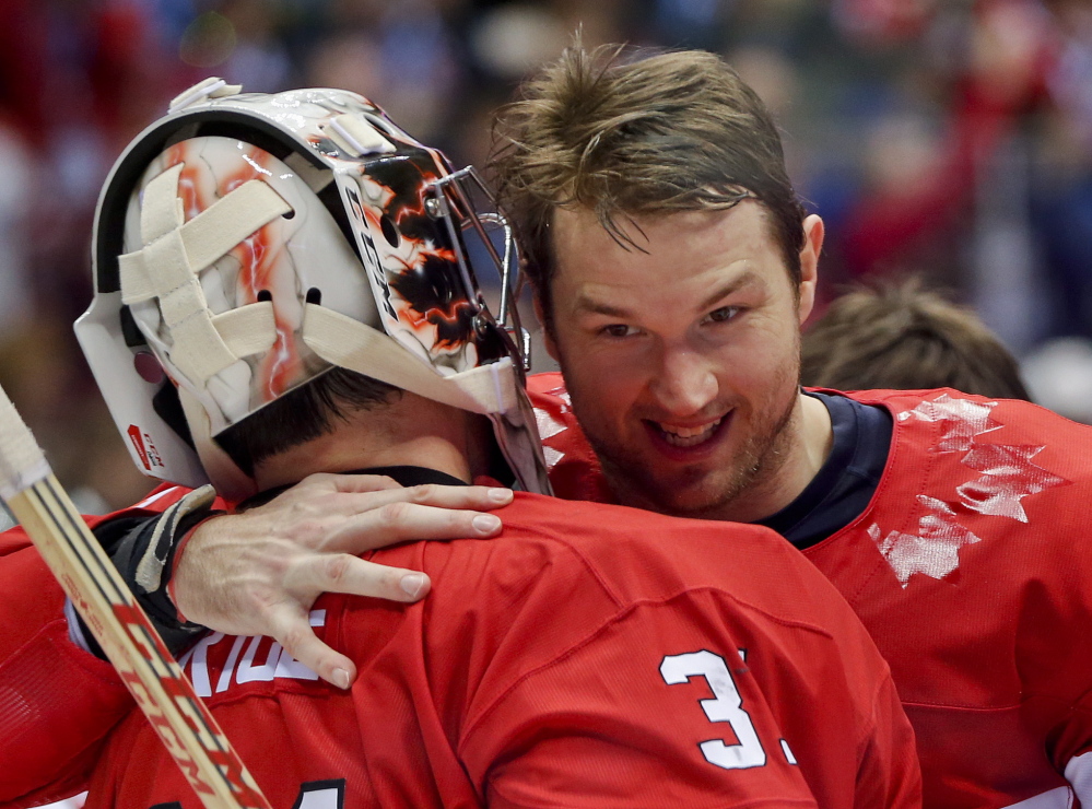 Canada forward Rick Nash congratulates goaltender Carey Price after Canada beat Sweden 3-0 in the men’s gold medal hockey game Sunday at the 2014 Winter Olympics in Sochi, Russia.