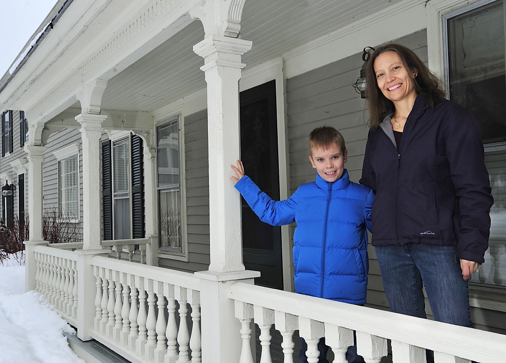 Susan Smith with her son Ethan, 7, at their farmhouse in Cumberland Center. The Smiths, who recently moved from Illinois, were among the first to sign up for natural gas when it becomes available in Cumberland Center.
