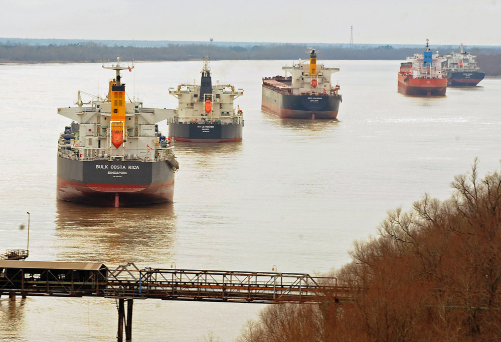 Ships sit idle along the banks of the Mississippi River on Monday, after a barge collision near Vacherie, La., on Saturday resulted in an oil spill. The Coast Guard reopened the normally bustling stretch of the Mississippi River on Monday.