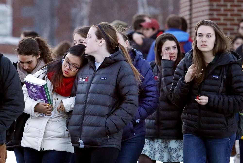 Emotions run high Monday as mourners pour out of Pettengill Hall at Bates College after a memorial service for John Durkin