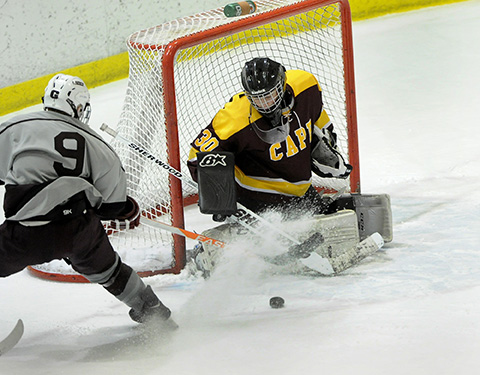 Greely's Reid Howland takes a shot on Cape's Grant Rusk during Tuesday's Class B West quarterfinal game at Family Ice Center in Falmouth.