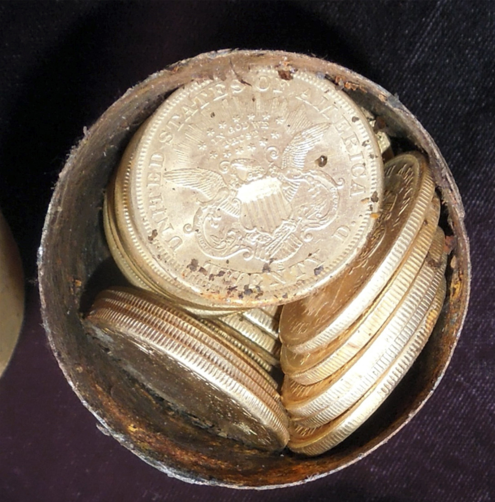 A metal canister is filled with gold coins found in Northern California.