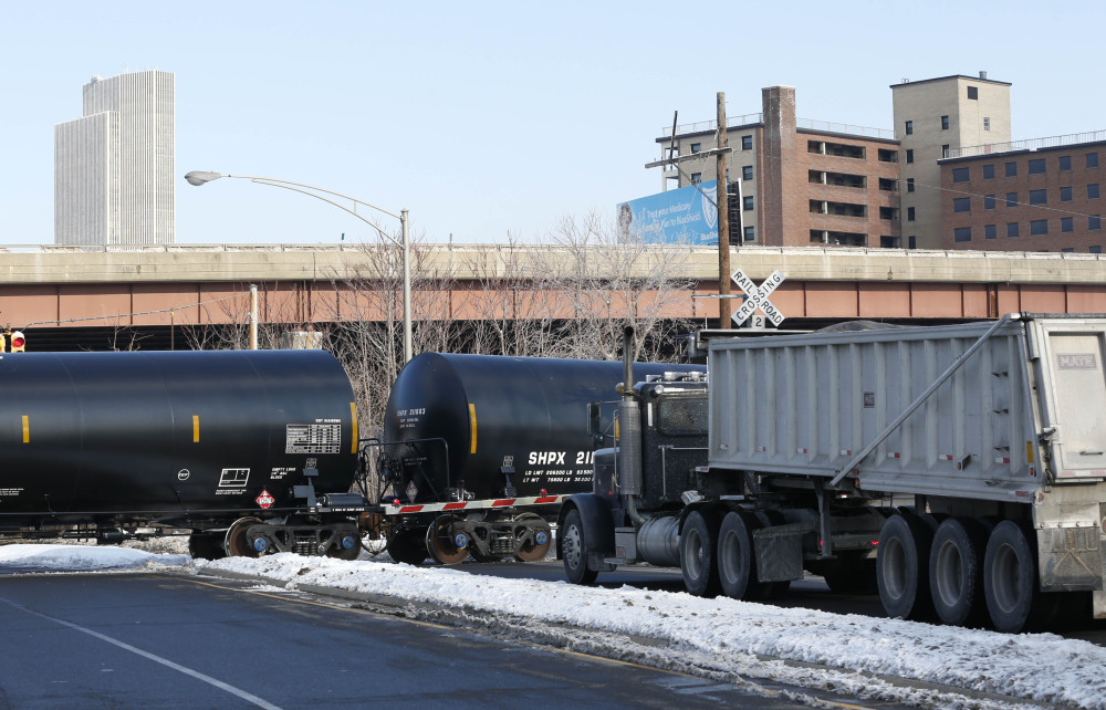 A truck waits as railroad oil tanker cars arrive at the Port of Albany this month in Albany, N.Y. The Port of Albany has become a hub for the U.S. oil business, taking shipments from North Dakota’s Bakken Shale daily by mile-long trains and shipping it in tankers down the Hudson River to refineries.