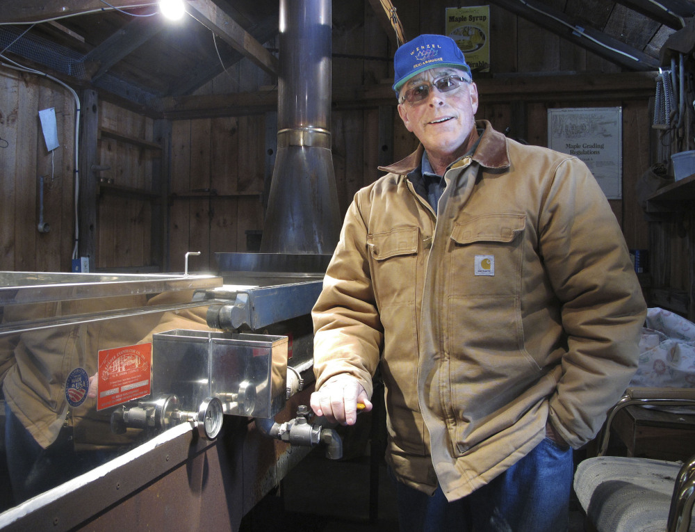 Maple syrup maker Ron Wenzel poses inside his sugar shack Tuesday in Hebron, Conn. He didn’t start tapping his trees until this past weekend, when temperatures in the 40s and 50s finally allowed the sap to flow.