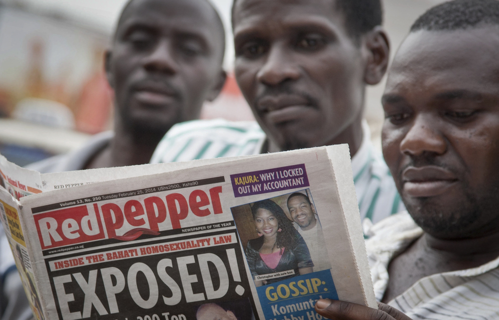 A man reads the Red Pepper tabloid newspaper containing a list of what it calls the country’s “top 200” homosexuals, in Kampala, Uganda, on Tuesday.