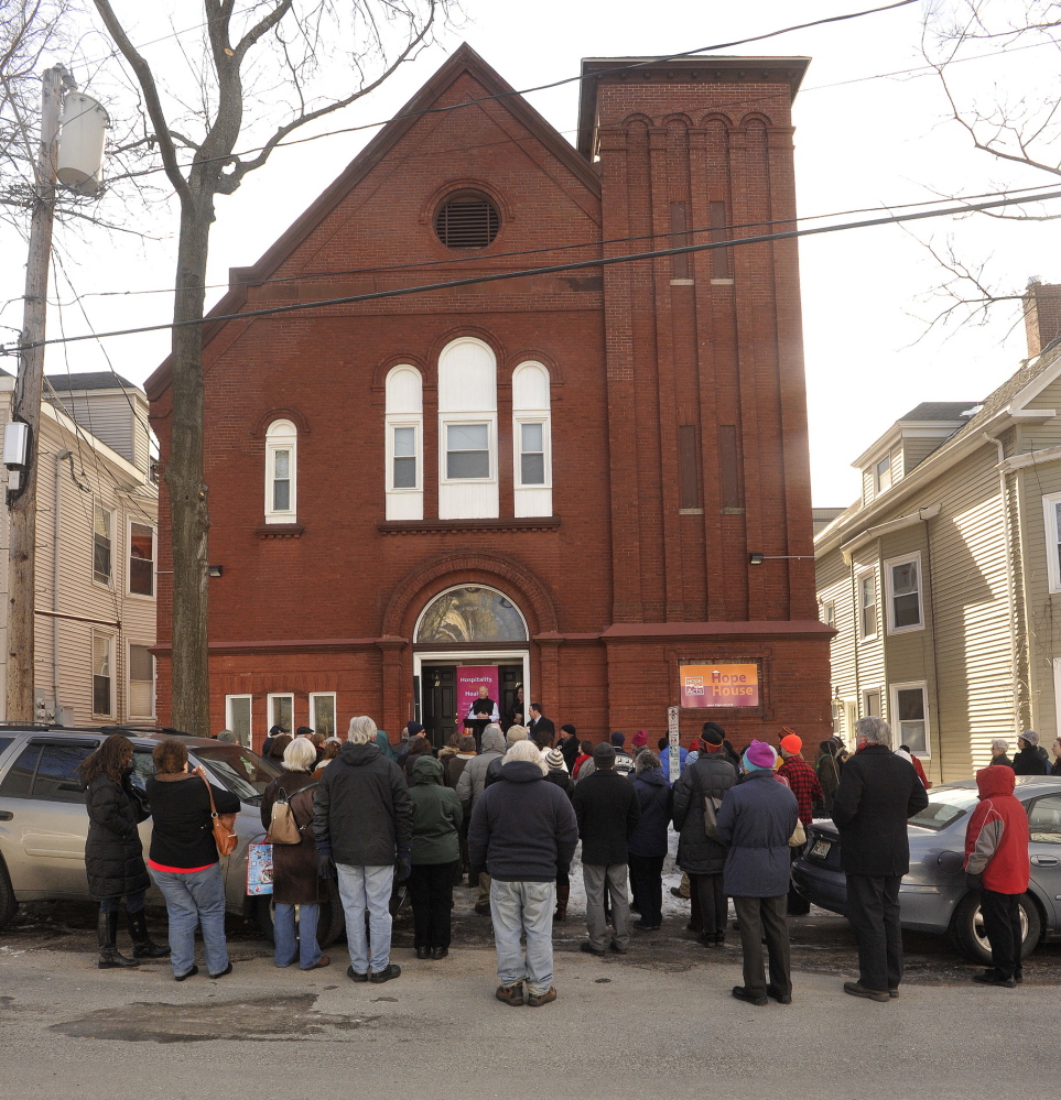 More than 50 people gather Tuesday on Sherman Street to celebrate Hope House, a recently completed home for newcomers who arrive in Portland alone and in need. The building, a former Lutheran church, has five apartments and a common living space.