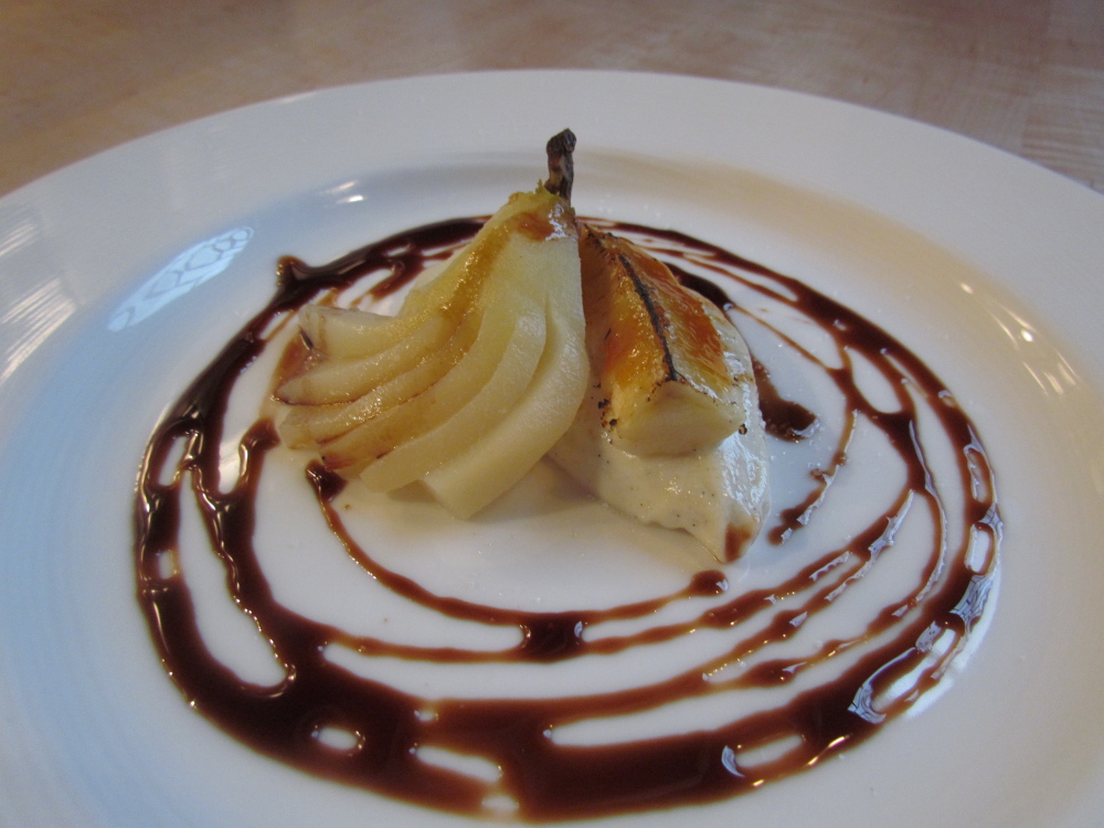 The perfect ending to the meal might include poached forrel pear, banana ricotta brulee with a balsamic reduction.
